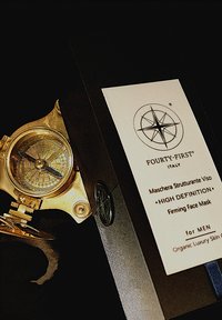 Gold-toned watch with intricate dial and compass design beside a black box labeled "FOURTY-FIRST ITALY" for a face mask.