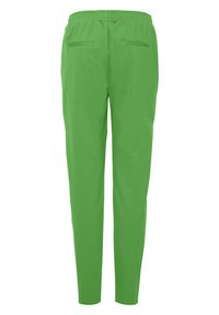 Gröna byxor med elastisk midja har en avsmalnande design med två bakfickor. Tillverkade av ett mjukt, lätt tyg med minimal struktur.