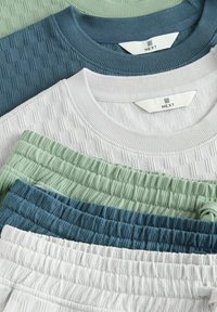 Set of cotton clothing items in light green, teal, white, and gray. Textured fabric with ribbed cuffs and elastic waistbands. Brand label visible.
