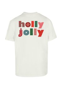 Valkoinen puuvillapaita, jossa on värikkäitä lohko-lettejä, jotka sanovat "holly jolly", kuvioina on raitoja, pallukoita ja lumihiutale.
