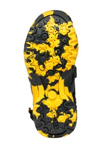 Suela de zapatilla negra y amarilla con patrones circulares texturizados y un diseño de banda de rodadura. Una parte está decorada con acentos en negro y amarillo.