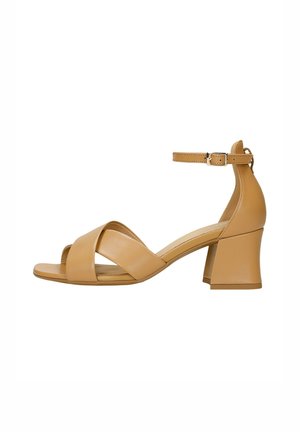 Beige leather high-heeled sandals with a block heel, featuring crisscross straps and an adjustable ankle strap. Smooth texture and minimal design.