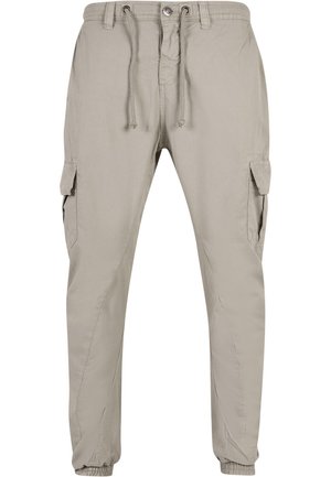 Pantalones cargo beige fabricados con tejido ligero, que cuentan con una cintura elástica, cordón de ajuste y dos bolsillos laterales tipo cargo.