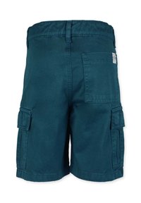 Kangar shorts tummansinisessä teal-värissä, joissa on joustava vyötärö, sivutaskut ja takatasku. Valmistettu kestävästä puuvillakankaasta.