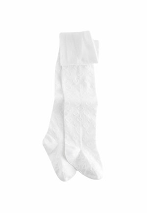 Witte sokken met een geribde rand en een patroon van hartjes. Gemaakt van een zachte, gestructureerde stof.