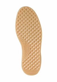 Semelle de chaussure en caoutchouc de couleur beige clair, présentant un motif en losanges texturé et surélevé, avec un logo près de l'arche pour l'adhérence et la traction.
