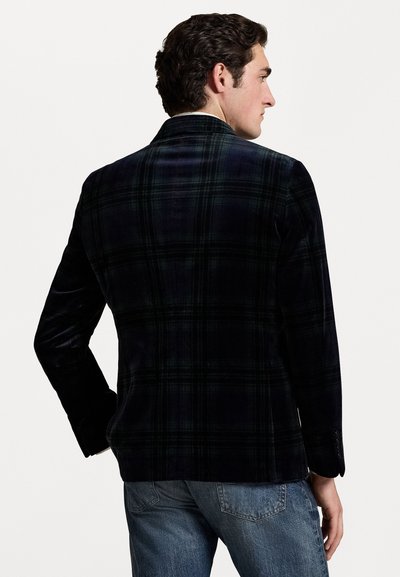 Blazer en velours pour homme de couleur bleu marine foncé avec un motif tartan vert, design à un bouton, et revers crantés. Accentué de coutures détaillées.