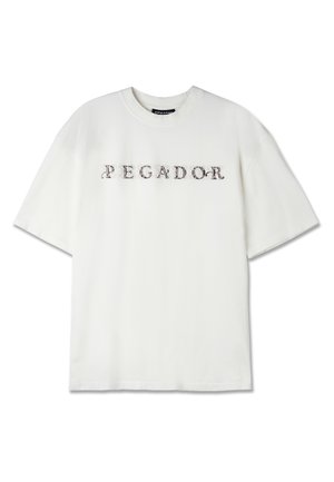 T-shirt bianca in cotone con scollo tondo e maniche corte, con la scritta "PEGADOR" stampata in caratteri decorativi scuri sulla parte anteriore.