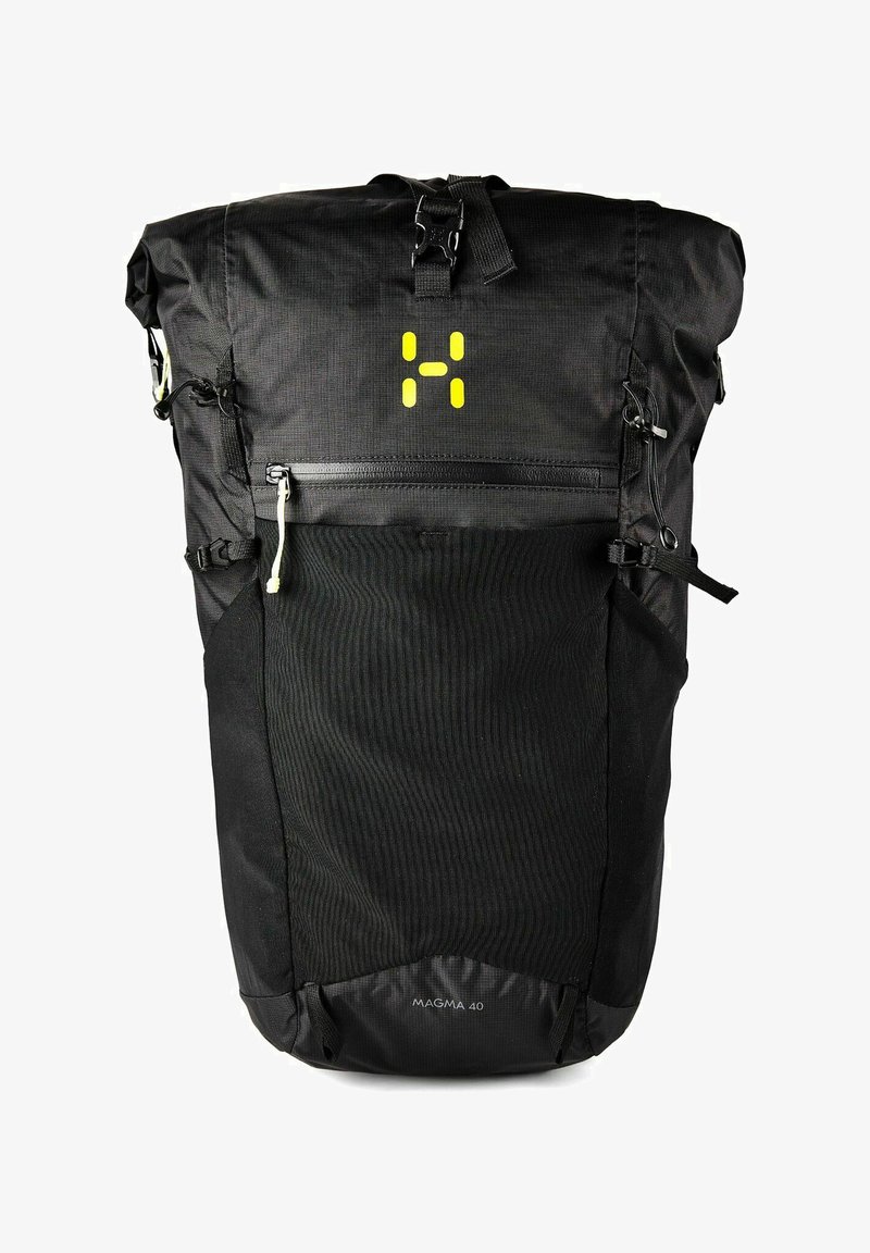 Mochila negra con cierre enrollable, bolsillo frontal con cremallera, logo amarillo, correas de compresión laterales y texto "MAGMA 40" en el centro inferior.