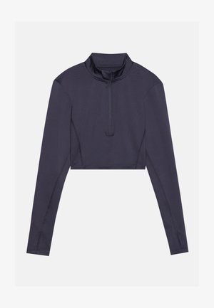 Korte, langlopende top van donkermarine stof. Heeft een hoge kraag en een halve rits aan de voorkant. Glad textuur met minimale stiknaad.