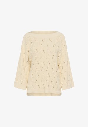Tejtrikó krém színben, széles bordázott bárhajó nyakkivágással és hullámos, nyitott munkájú cable mintázattal a testen és a széles ujjakon.