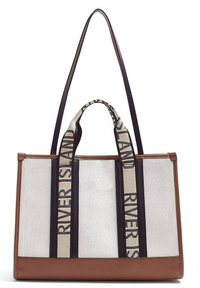 Tote-väska med brun läderbotten, läkevidd av canvas och svarta remmar som har ett mönstrat krämfärgat inslag. Rektangulär form med dubbla handtag.