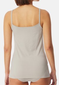 Gray tank top with thin straps, crafted from soft, smooth fabric. Straight cut, simple design, and low back detail.