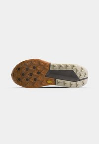 Rubber shoe sole with a combination of brown and cream colors. Features a traction pattern with heart-shaped lugs for grip and stability.