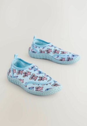 Light blue slip-on shoes featuring a playful cartoon pattern with characters in pink and blue. Soft fabric with textured outsole for traction.