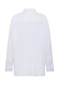 Vit långärmad skjorta med krage, med en rak passform, sidofållar och knappade manschetter med ett fint broderat mönster på ärmarna.