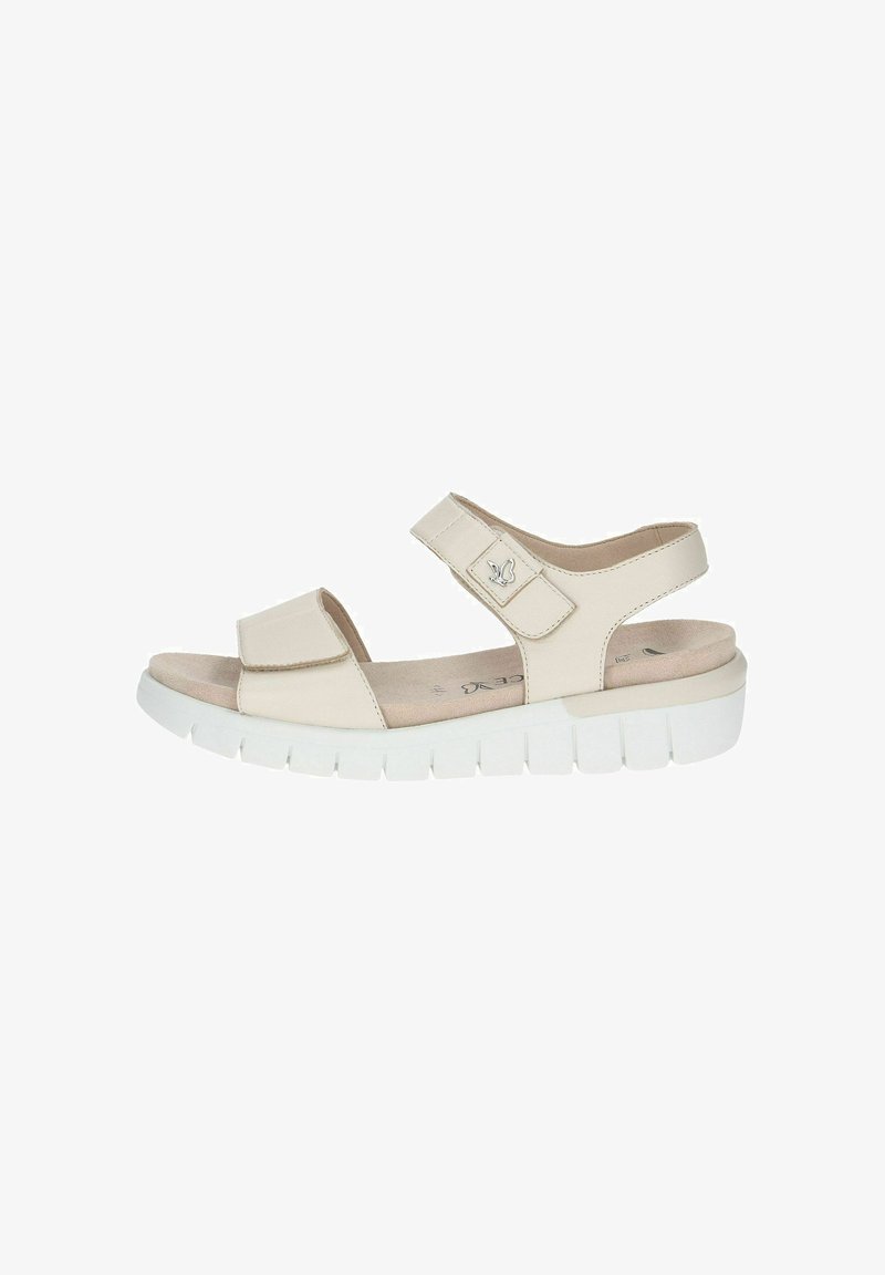 Beige sandal with two adjustable Velcro straps, open toe, cushioned footbed, and a white, chunky sole with grooves for traction.