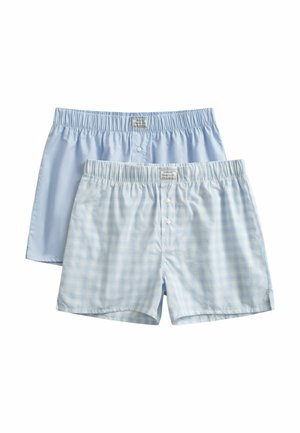 Deux paires de boxers en coton pour hommes, l'une uni bleu clair et l'autre bleu clair avec un petit motif à carreaux, toutes deux avec ceintures élastiques et boutons à l'avant.
