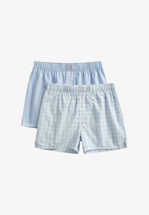 Dva páry pánských bavlněných boxerek, jeden v jednolité světle modré barvě a druhý světle modrý s drobným kostkovaným vzorem, oba s elastickým pasem a předními knoflíky.