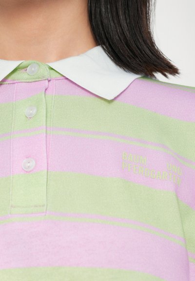 Striped polo shirt featuring alternating light green and pink stripes, a white collar, and four buttons with subtle brand embroidery.