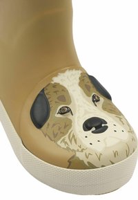 Botte en caoutchouc de couleur beige avec un motif de visage de chien. Présente des accents noirs pour les oreilles et des textures brunes. Semelle blanche texturée pour une meilleure adhérence.