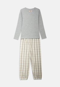 Gray long-sleeve top with a round neckline paired with cream and tan plaid pajama pants with an elastic waistband and cuffed ankles.