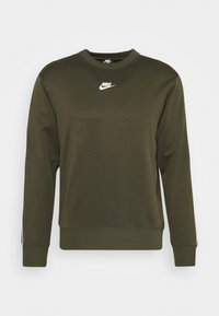 Olive green Nike sweatshirt, soft fabric, crew neck, long sleeves, white logo on chest, ribbed cuffs and hem, minimalistic design.