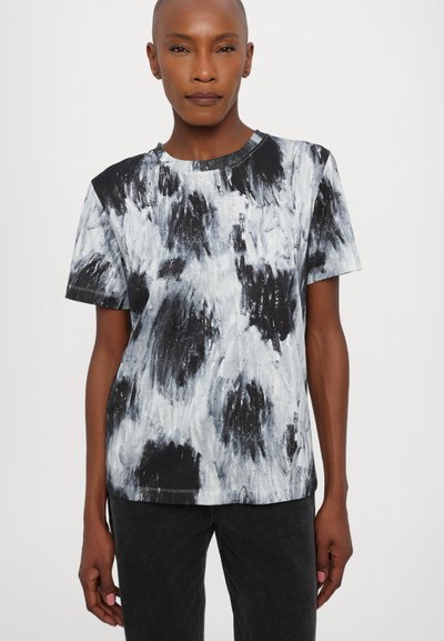 Melnbalts abstrakts prints T-kreklā ar īsām piedurknēm, apaļu kakla izgriezumu un brīvu piegriezumu. Audumam ir mīksta tekstūra, minimālas šuvju detaļas.