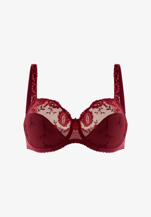 Czerwony stanik z przezroczystymi miseczkami z siateczki, kwiatowym haftem, dekoracyjnymi ramiączkami i falbaniastymi krawędziami. Posiada fiszbiny dla wsparcia oraz centralny detal w postaci kokardki.