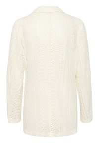Pitskåpe i off-white med et teksturert mønster, med krage og lange ermer. Åpen ryggdesign med intrikat detaljer.