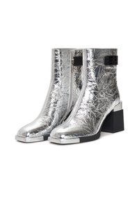 Silver metallic ankle boots with a textured finish, square toe, and chunky black heel. Features a side zipper and black accent details.