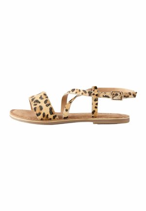Leopardenmuster Flachsandalen mit zwei Kreuzriemen und einer verstellbaren Schnalle, ausgestattet mit einer weichen beigefarbenen Fußbett und einer glatten tanfarbenen Sohle.