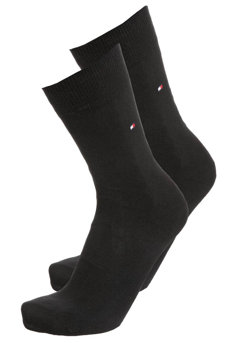 Schwarze Baumwollsocken mit einem gerippten Bund, versehen mit einem kleinen Logo auf der Oberseite. Glatte Textur und knöchellanges Design.