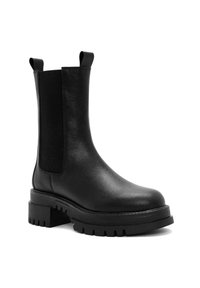 Black leather ankle boots feature elastic side panels, pull tabs, chunky rubber soles, and round toes with a textured pattern on the sole.