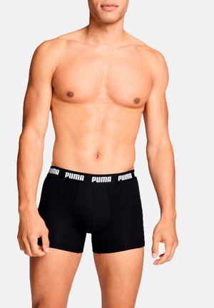 Black cotton boxer briefs with a white elastic waistband featuring "PUMA" logo. The design is form-fitting and smooth-textured.
