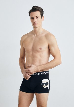 Černé bavlněné boxerky mají grafický design obličeje se slunečními brýlemi. Pas je zdoben bílým nápisem "KARL LAGERFELD".