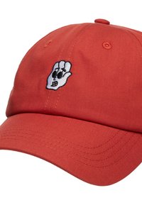 Red cotton cap featuring a white embroidered hand with facial features. Cap has a curved brim and stitched detailing along the edges.