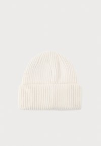 Knit beanie in off-white, featuring ribbed texture, fold-over cuff, and a tapered top. Soft material suitable for cold weather.