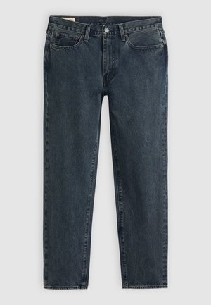 Jean droit en denim foncé avec bouton à l'avant, fermeture éclair et style cinq poches, posé à plat sur un fond clair.