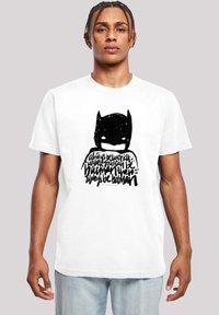 White cotton t-shirt featuring a black stylized Batman graphic with handwritten text below. Short sleeves, crew neck design, relaxed fit.
