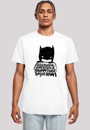 White cotton t-shirt featuring a black stylized Batman graphic with handwritten text below. Short sleeves, crew neck design, relaxed fit.