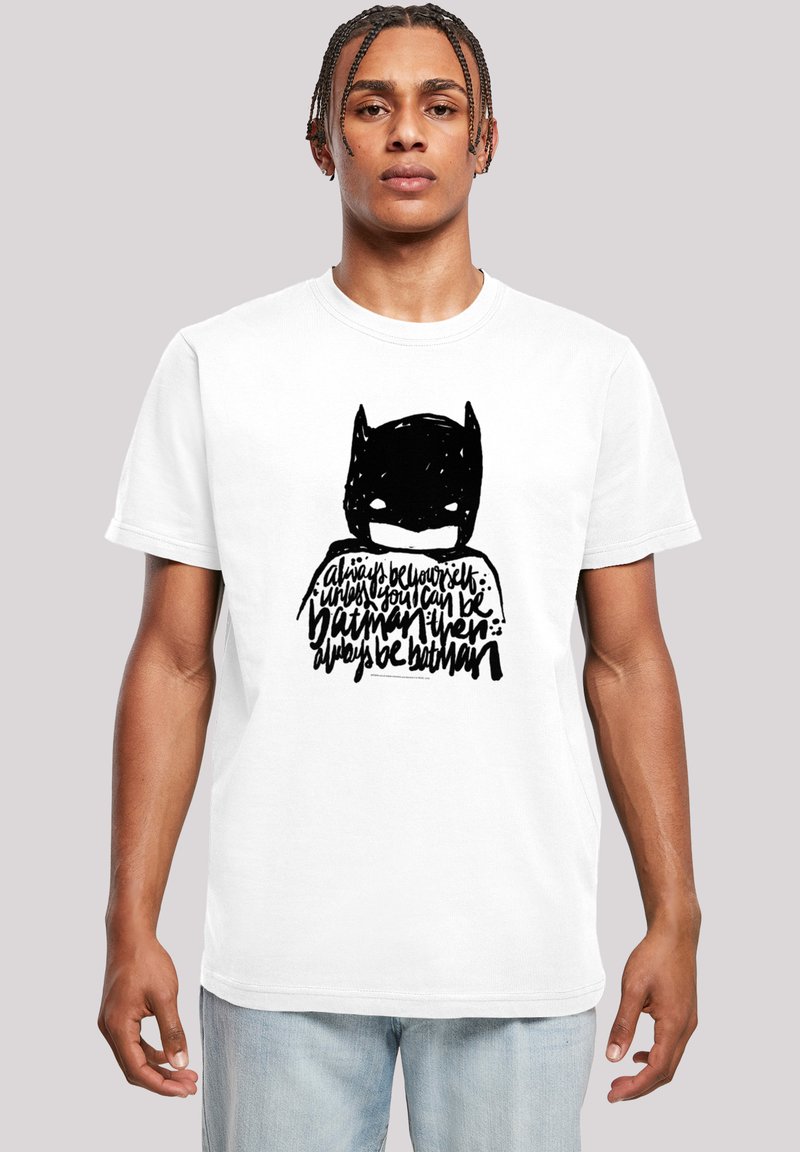 White cotton t-shirt featuring a black stylized Batman graphic with handwritten text below. Short sleeves, crew neck design, relaxed fit.