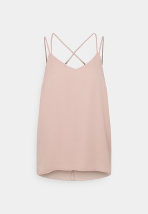 Blouse sans manches rose clair avec fines bretelles doubles croisées dans le dos et un ourlet légèrement arrondi.