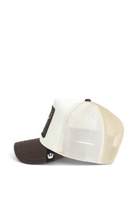 Cappello con visiera in tessuto marrone, pannello anteriore crema e retro in rete beige. Presenta una toppa nera sulla parte frontale e un'etichetta con il logo sul lato.