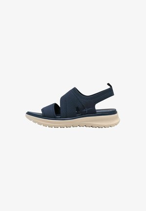 Dunkelblaue Sandale mit strukturiertem Obermaterial, elastischen Riemen, verstellbarem Fersenbereich und leichter Gummisohle mit Profilmuster für besseren Halt.