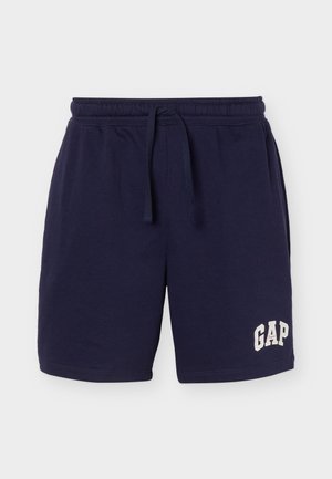 Navyblå bomullsshorts med elastisk midje og snor, med hvit «GAP»-logo på venstre ben.