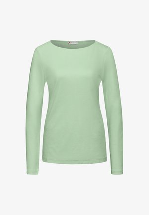 Jasnozielona bluzka z długim rękawem, wykonana z miękkiego, gładkiego materiału; ma okrągły dekolt i dopasowany krój, bez wzorów ani ozdób.