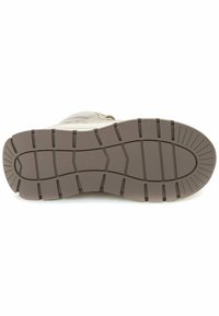 Sole di sneaker marrone chiaro con una presa a motivo. Il battistrada presenta scanalature profonde e sezioni rialzate per una migliore aderenza. Materiale in gomma con finitura texture.