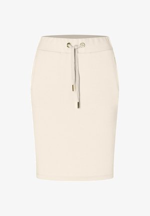 Beige puuvillaseguskaitse, millel on elastne vöökoht, pael ja kuldse tooniga silmad. Sile tekstuur, põlve pikkune disain, ilma mustriteta.