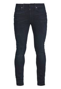 Jeans ajustados azul oscuro hechos de denim. Cuenta con cinco bolsillos, cremallera y una textura lisa y elegante. Sin desgaste visible ni adornos.